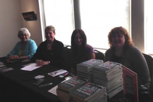 Suffolk Mystery Authors Festival table with Virginia is For Mysteries, Heather Weidner, Vivian Lawry,