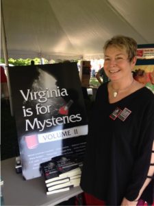 Vivian Lawry standing by signing table at Radford Reads with Virginia is for Mysteries: Volume II