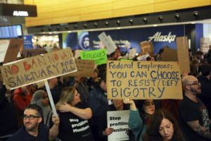 More than 1,000 people gather at Seattle-Tacoma International Airport, to protest President Donald Trump's order that restricts immigration to the U.S., Saturday, Jan. 28, 2017, in Seattle. President Trump signed an executive order Friday that bans legal U.S. residents and visa-holders from seven Muslim-majority nations from entering the U.S. for 90 days and puts an indefinite hold on a program resettling Syrian refugees. (Genna Martin/seattlepi.com via AP)
